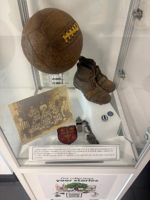 Museum Box with a football, football boots, picture of football team and badges